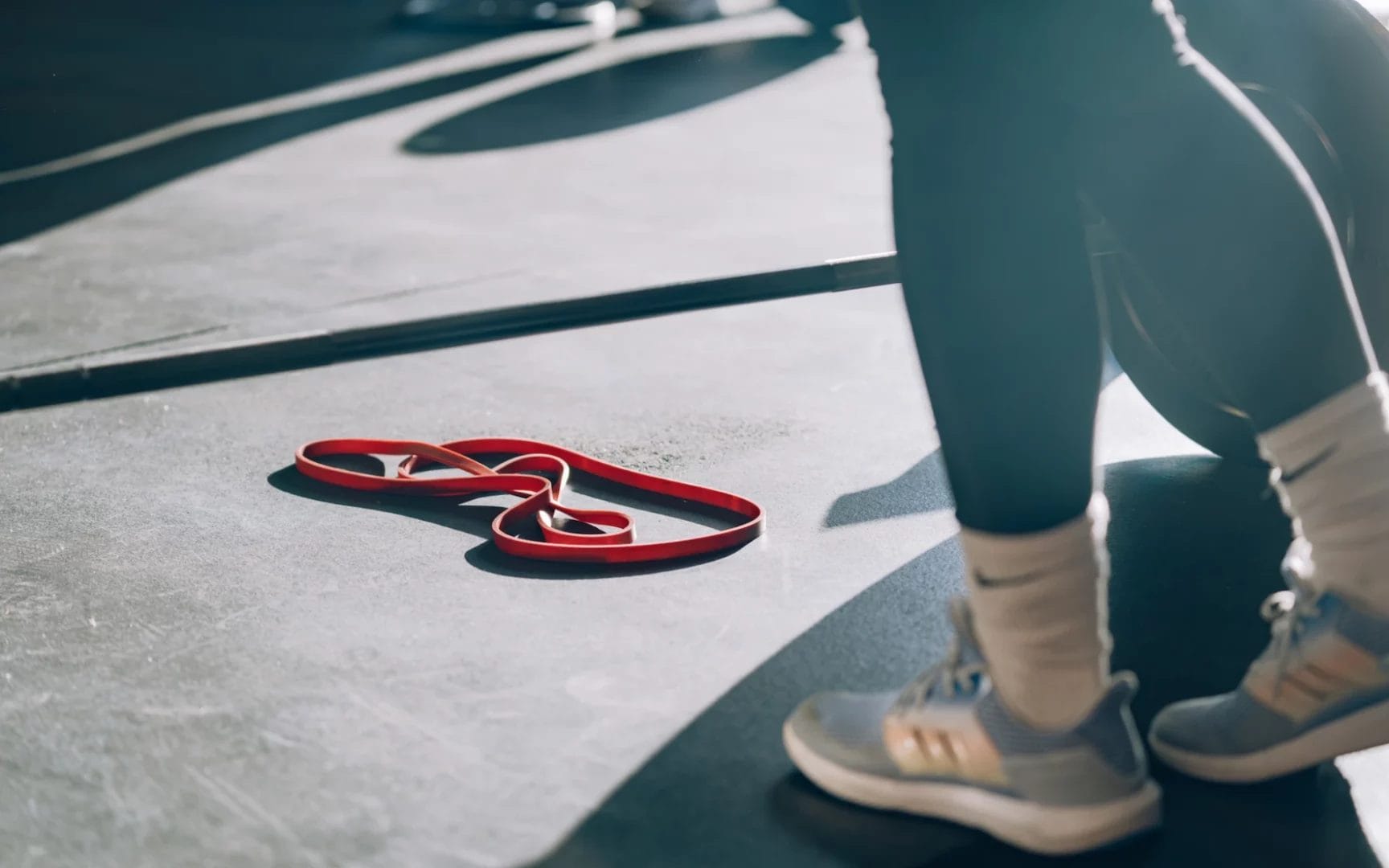 womans legs and gum rope on floor